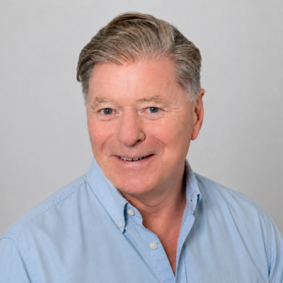 Alan Hall, counsellor, smiling to camera in a light blue shirt.